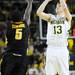 Michigan senior Matt Vogrich lines up a shot over Iowa freshman Anthony Clemmons in the second half at Crisler Center on Sunday, Jan. 6. Michigan beat Iowa 95-67 in the Big Ten home opener. Melanie Maxwell I AnnArbor.com